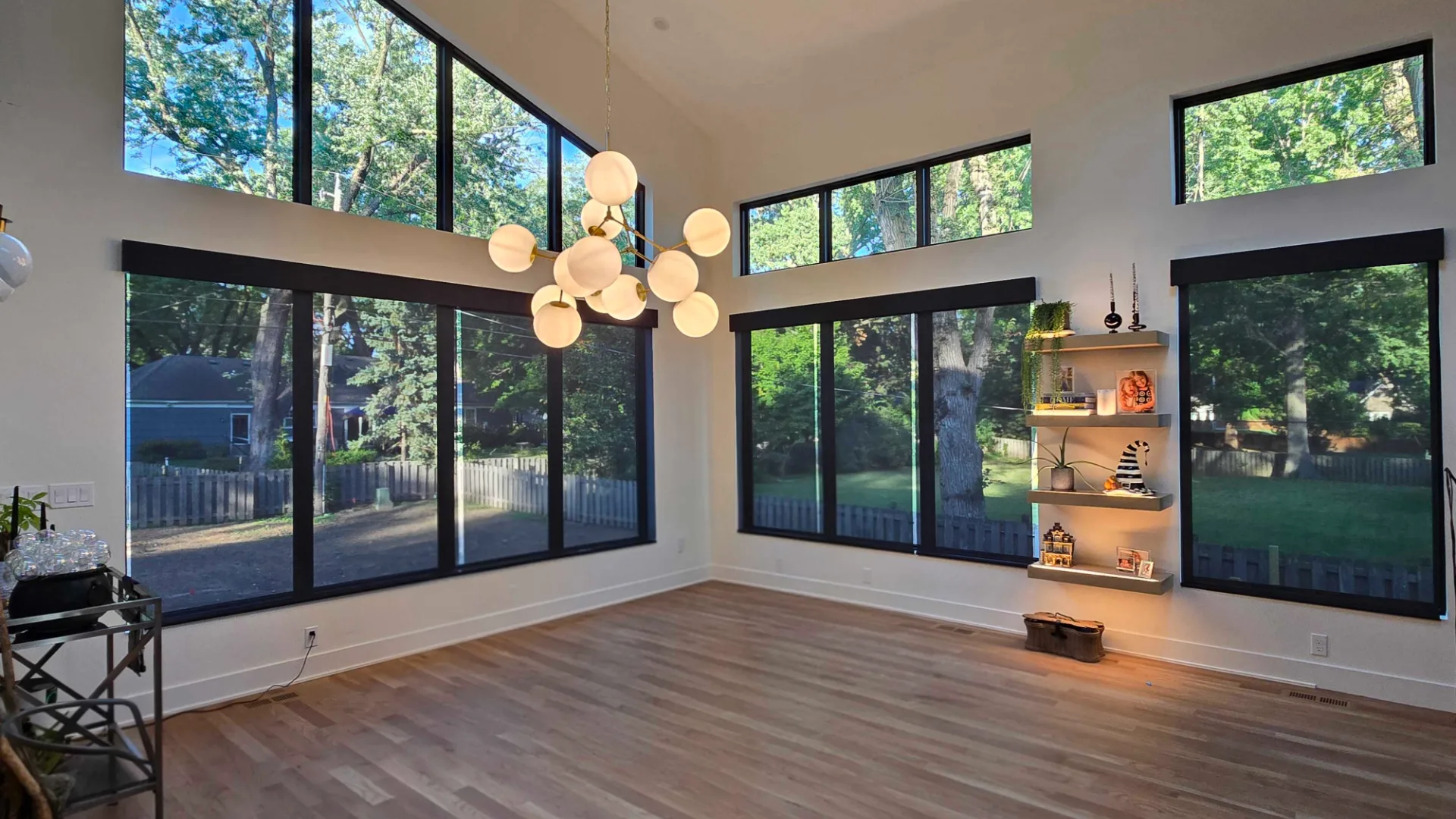 Motorized screen shades filling a bright modern Kansas City living room with floor-to-ceiling windows