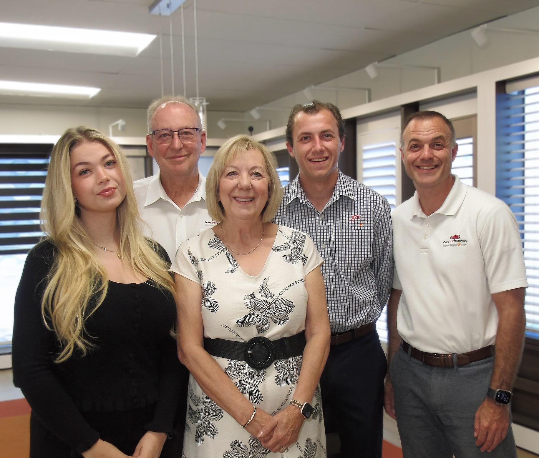 The Roellchen family and the One Stop Decorating team at a Kansas City showroom — three generations, family-owned since 1995